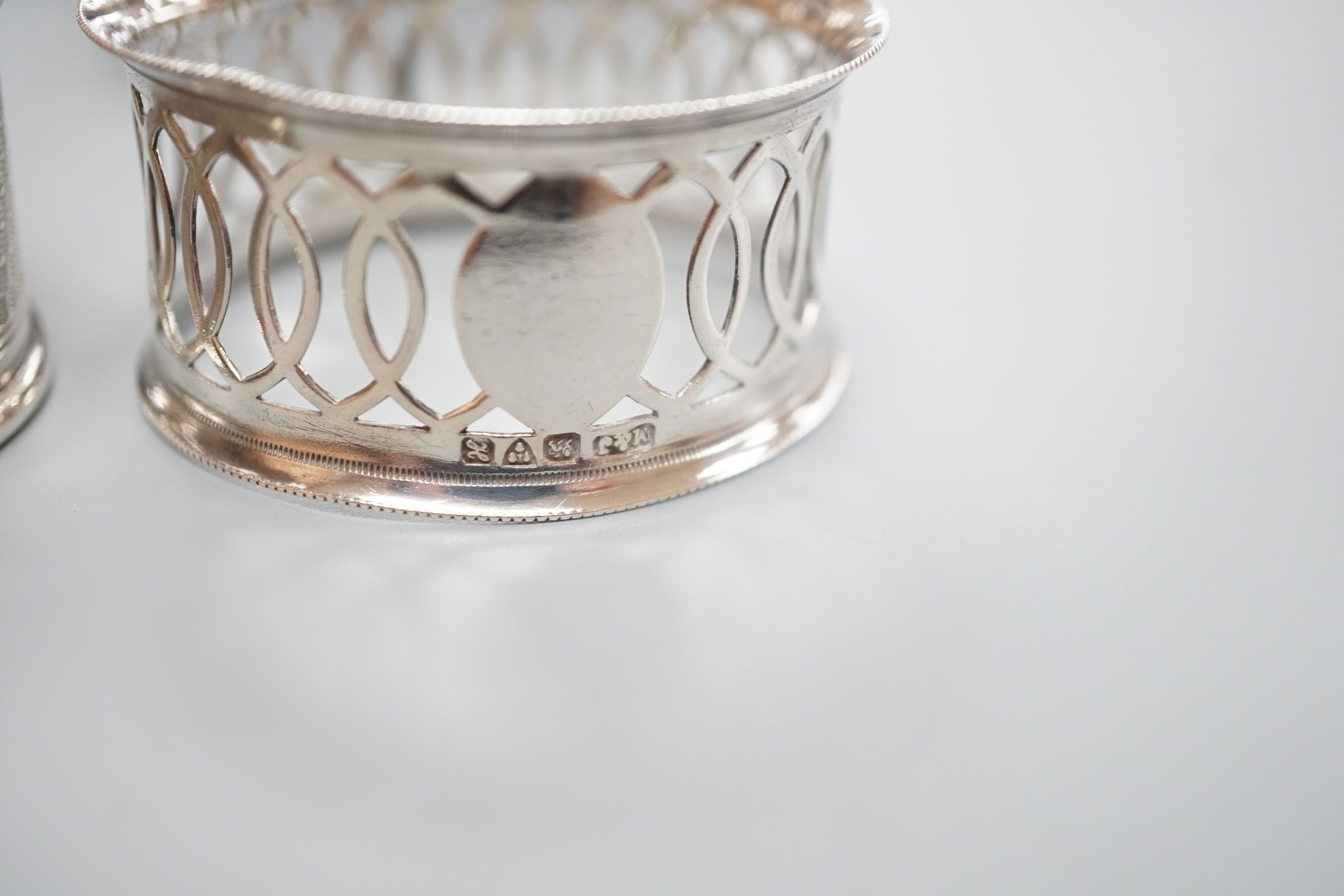A cased pair of George V engine turned silver napkin rings, by Charles Horner, Chester, 1923 and an Edwardian cased pair of silver napkin rings.